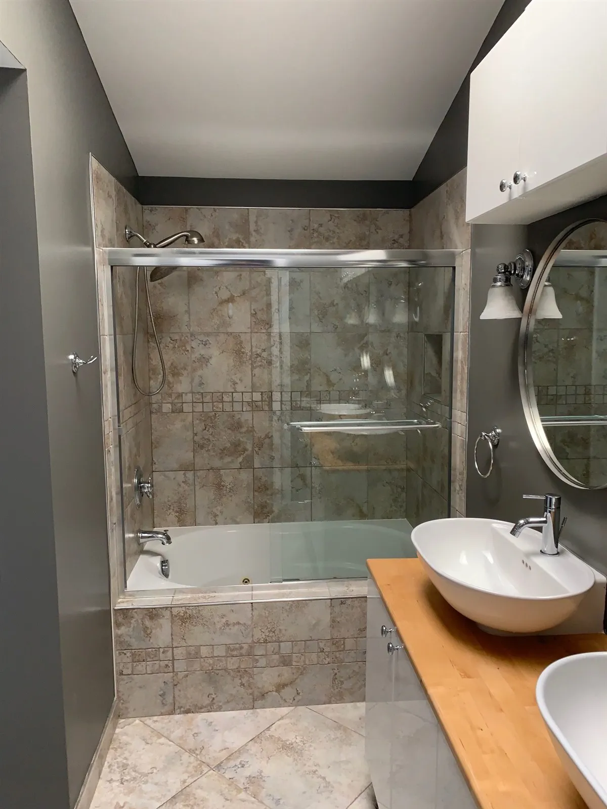 Remodeled bathroom with a glass shower and vessel sink