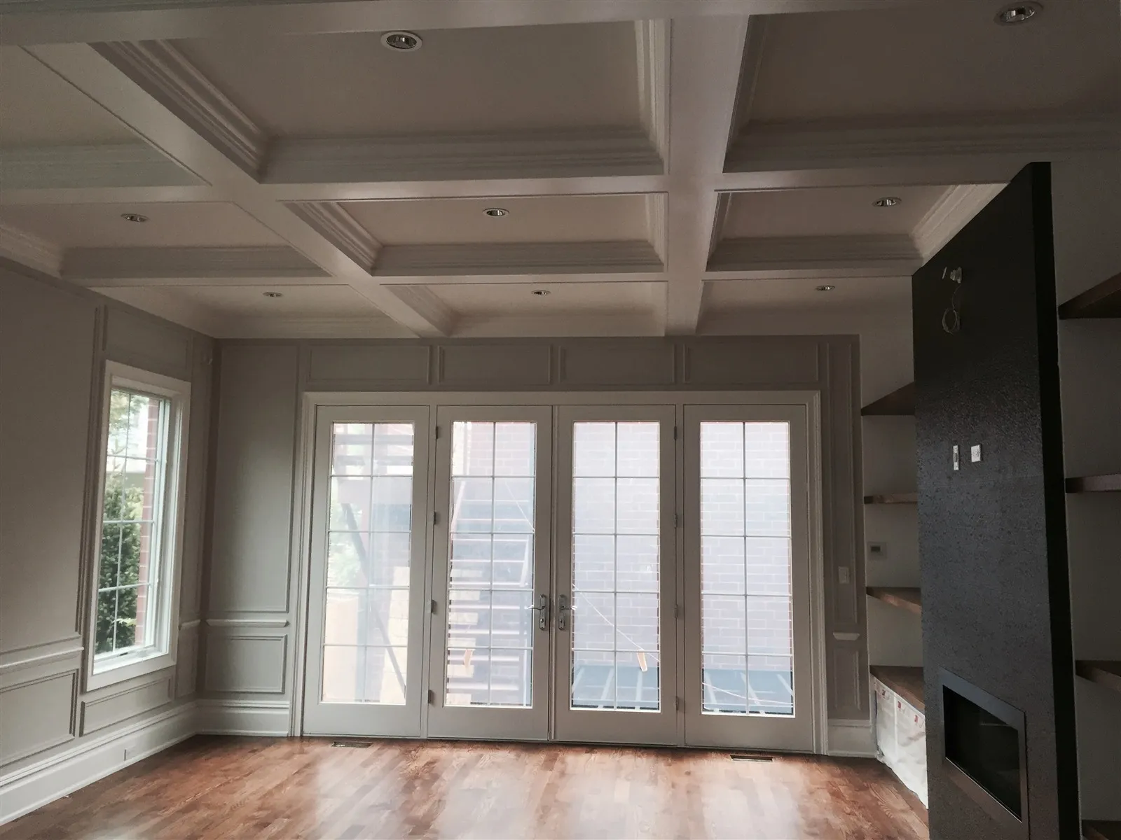 Living room with a new coffered ceiling and French doors